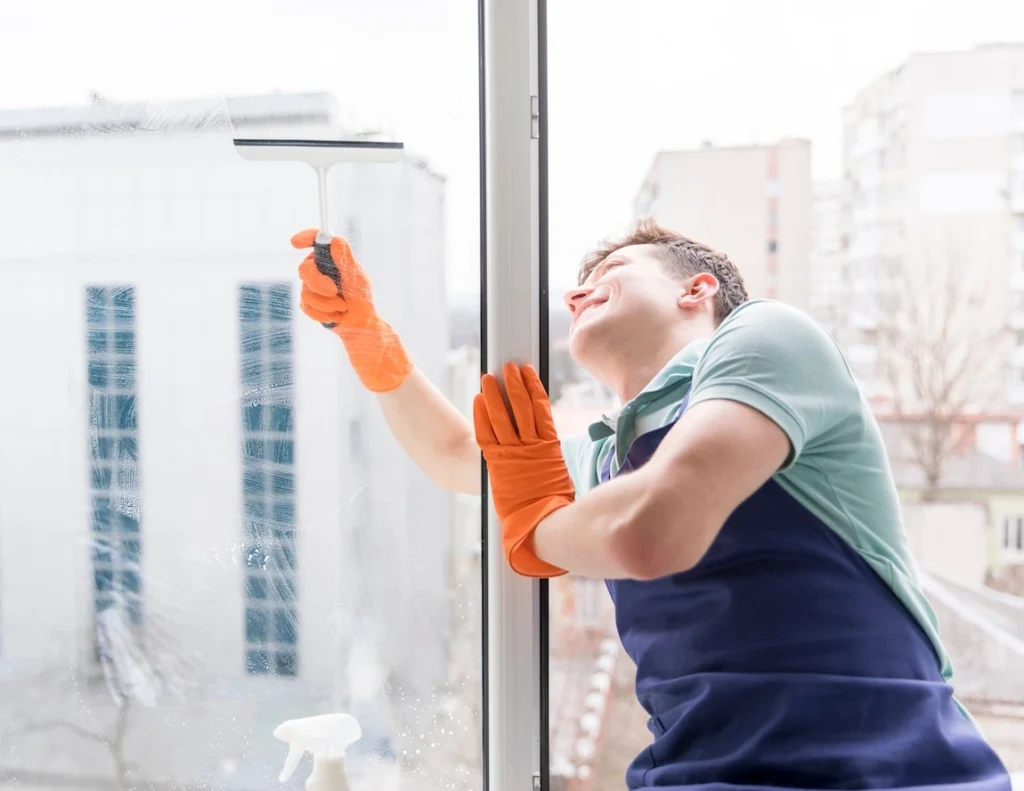 Smiling Easy Life Solution cleaner using a squeegee for window cleaning in Walnut Creek CA