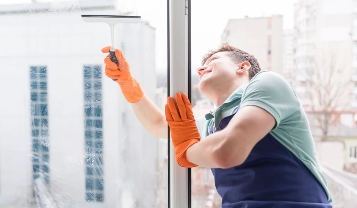 Smiling Easy Life Solution cleaner using a squeegee for window cleaning in Walnut Creek CA